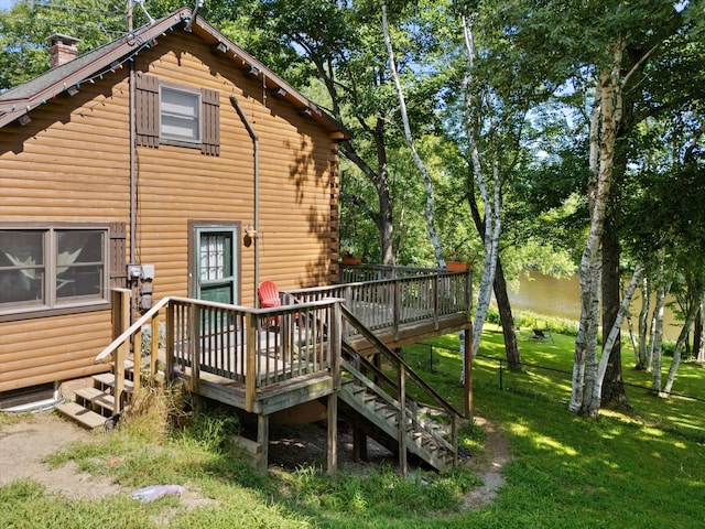 back of house featuring a yard and a deck