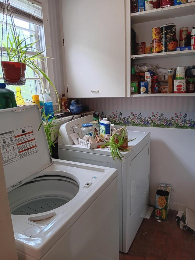 laundry area featuring independent washer and dryer and cabinets