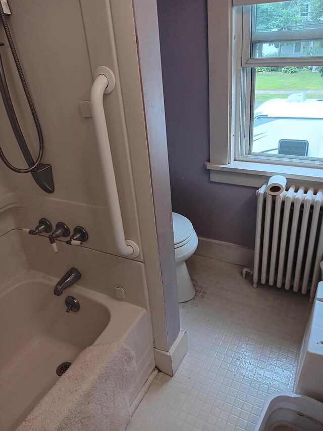 bathroom featuring tile patterned floors, toilet, and radiator heating unit