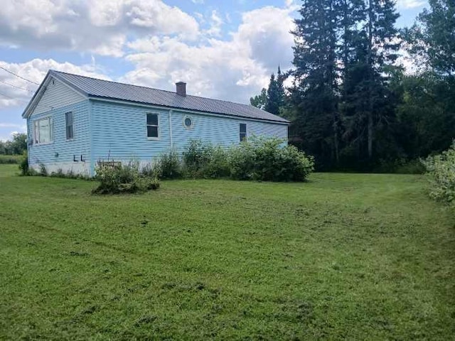 back of house with a lawn