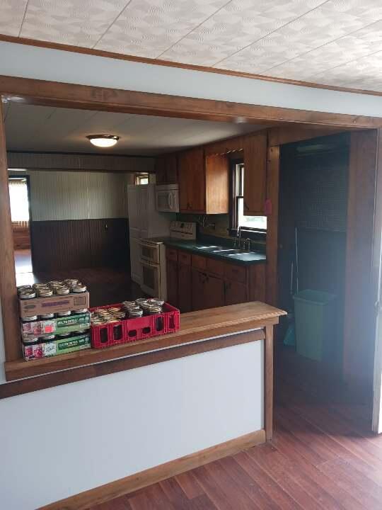 kitchen featuring sink, range with two ovens, and hardwood / wood-style floors