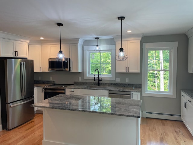 kitchen featuring appliances with stainless steel finishes, plenty of natural light, sink, and a baseboard radiator