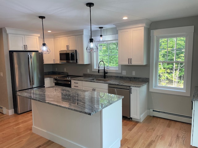 kitchen with sink, light wood-type flooring, white cabinetry, stainless steel appliances, and baseboard heating