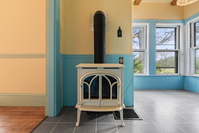 room details with tile patterned floors and a wood stove