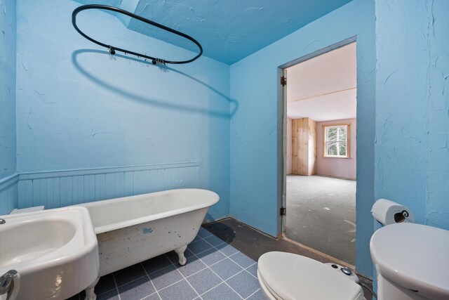 bathroom with sink, toilet, and tile patterned floors