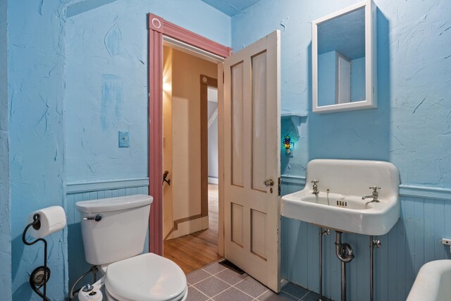 bathroom featuring sink, wood-type flooring, and toilet