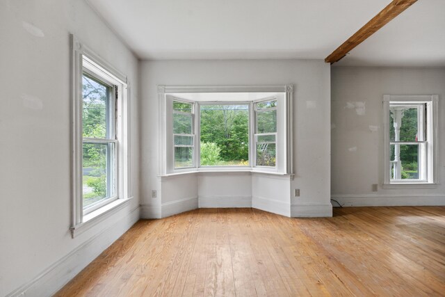 unfurnished room with light wood-type flooring