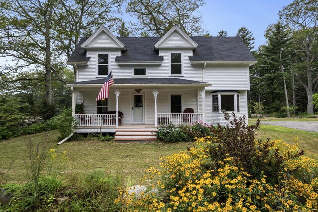 view of front of property with a porch and a front yard