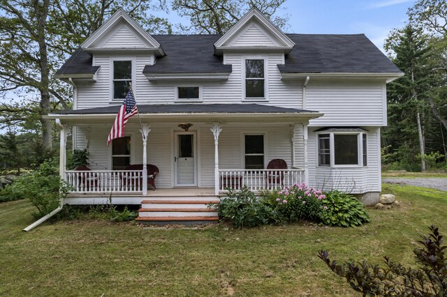 view of front of house with a porch and a front yard