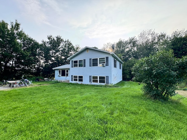 back of property featuring a lawn