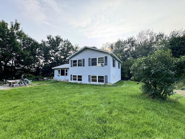 rear view of house featuring a lawn