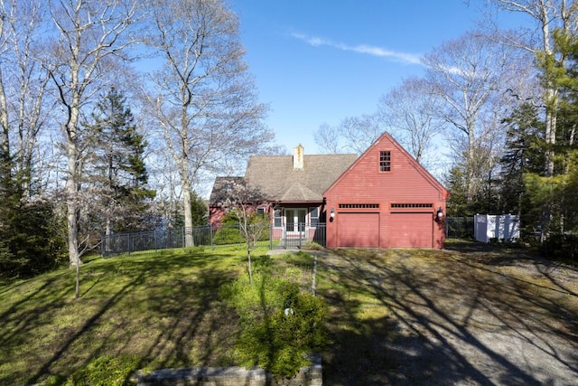 view of front of home with a garage, a front lawn, and a porch