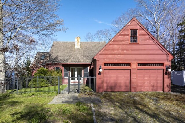 view of front of home with a garage and a front yard