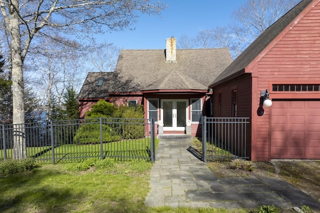 exterior space featuring a front yard and french doors