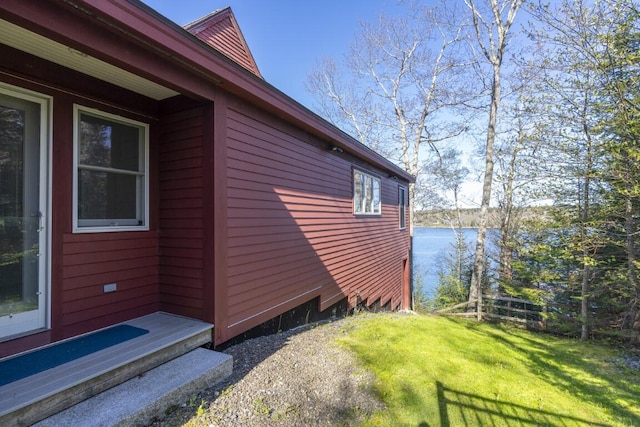 view of side of property featuring a yard and a water view