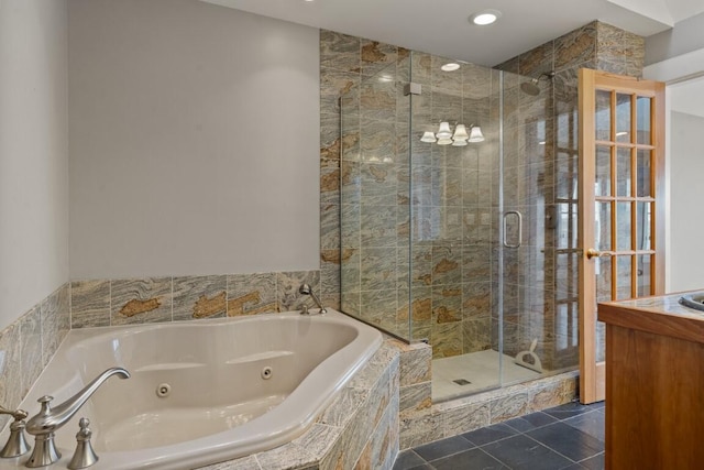 bathroom with tile patterned flooring and shower with separate bathtub