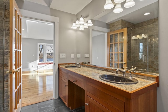 bathroom with vanity and a shower with door