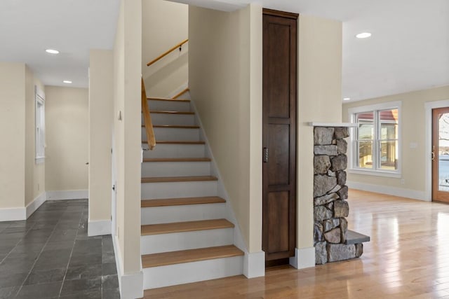 stairs featuring hardwood / wood-style floors