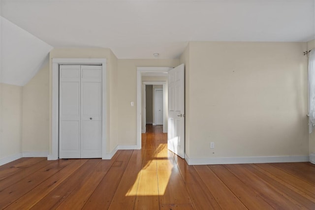 unfurnished bedroom with light hardwood / wood-style floors and a closet