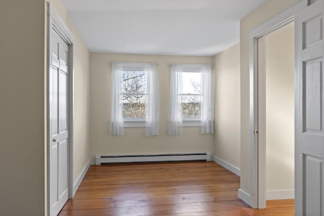 interior space featuring light hardwood / wood-style floors and a baseboard heating unit