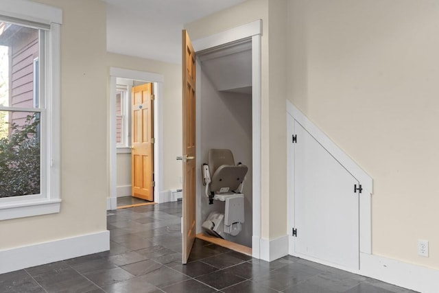 corridor with a baseboard radiator and plenty of natural light