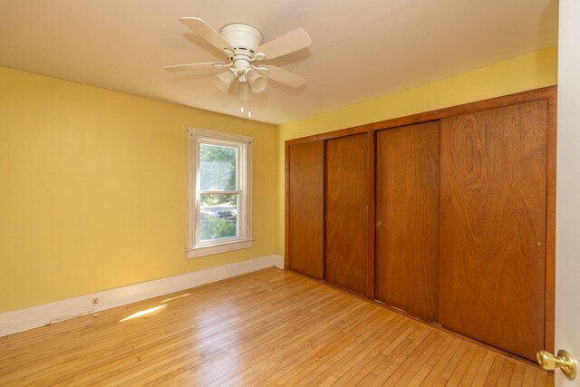 unfurnished bedroom with light wood-type flooring, a closet, and ceiling fan