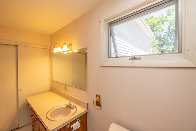 bathroom featuring a healthy amount of sunlight and vanity