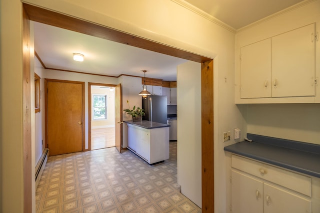 kitchen with stainless steel refrigerator, crown molding, baseboard heating, hanging light fixtures, and white cabinets