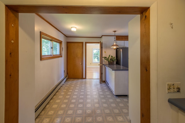 interior space featuring stainless steel fridge, baseboard heating, and pendant lighting