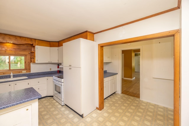 kitchen featuring white electric range, white cabinets, light hardwood / wood-style floors, and sink