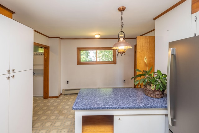 kitchen featuring stainless steel fridge, hanging light fixtures, ornamental molding, white cabinetry, and a baseboard heating unit