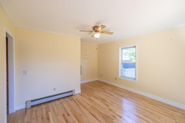 spare room with crown molding, baseboard heating, light wood-type flooring, and ceiling fan