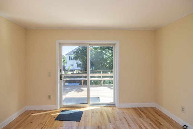 entryway with light wood-type flooring and crown molding