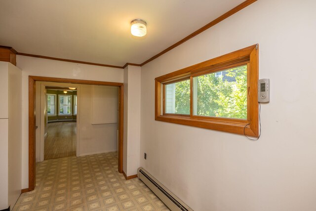 unfurnished bedroom featuring crown molding, light hardwood / wood-style floors, baseboard heating, and a closet