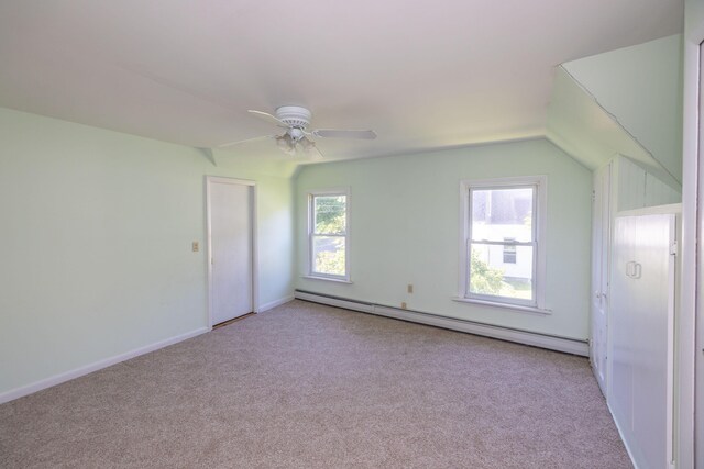 bonus room with a baseboard heating unit, ceiling fan, light carpet, and vaulted ceiling