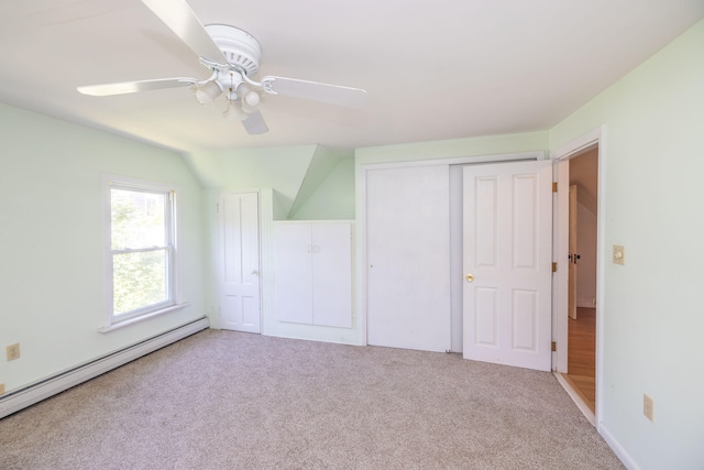 unfurnished bedroom with a closet, baseboard heating, light carpet, and ceiling fan