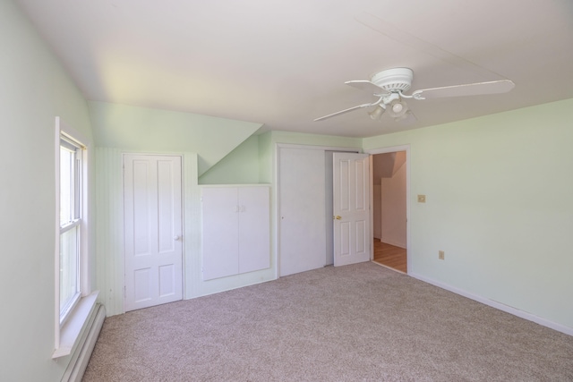 unfurnished bedroom featuring light carpet, multiple windows, and ceiling fan