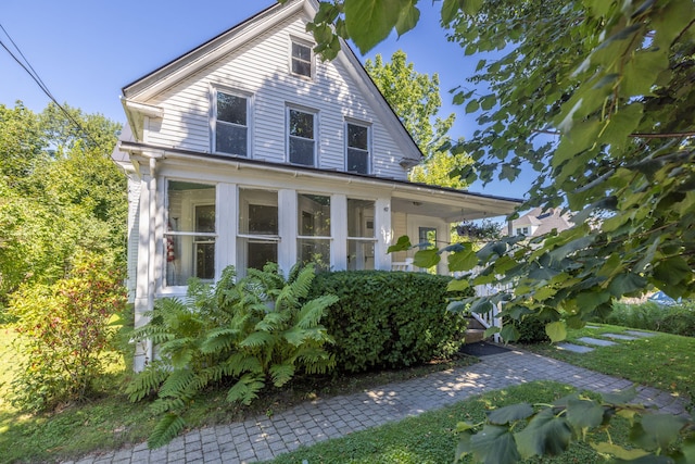 view of front of property featuring a sunroom