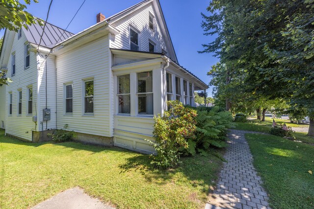 view of side of home featuring a yard