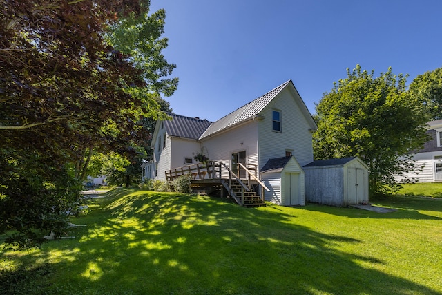 rear view of house with a storage unit and a lawn