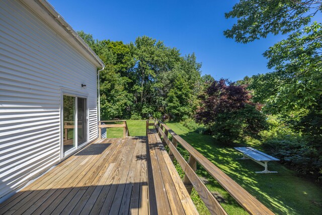 wooden terrace featuring a yard