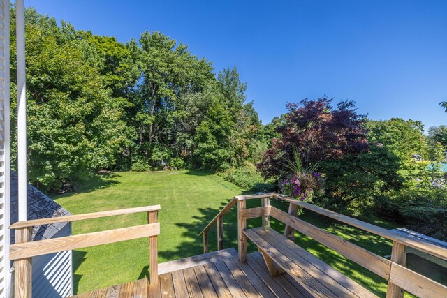 wooden deck featuring a yard