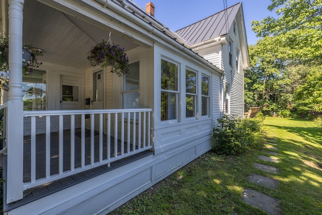 view of home's exterior featuring a lawn and a porch