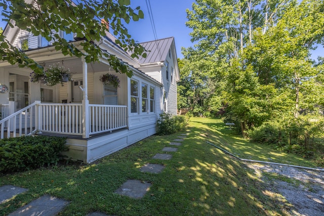 view of side of home with a yard