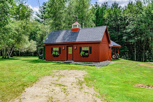 view of front facade with an outbuilding and a front yard