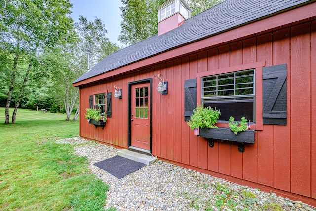 view of outbuilding featuring a yard