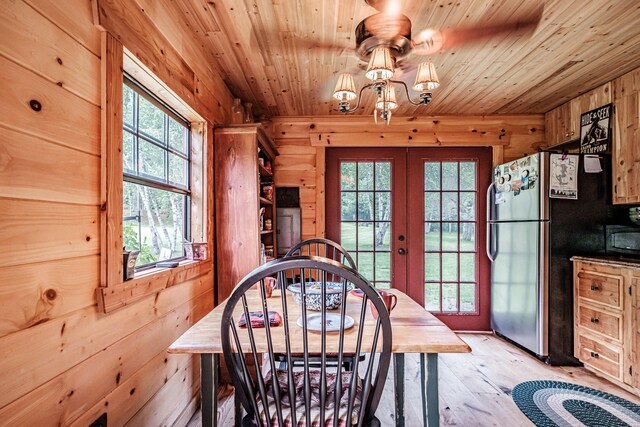 dining area with a wealth of natural light, french doors, wood ceiling, and light wood-type flooring