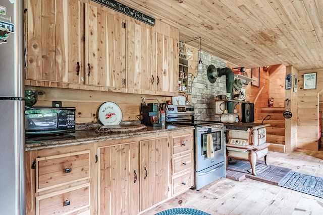 kitchen with appliances with stainless steel finishes, a wood stove, wooden ceiling, and light brown cabinetry