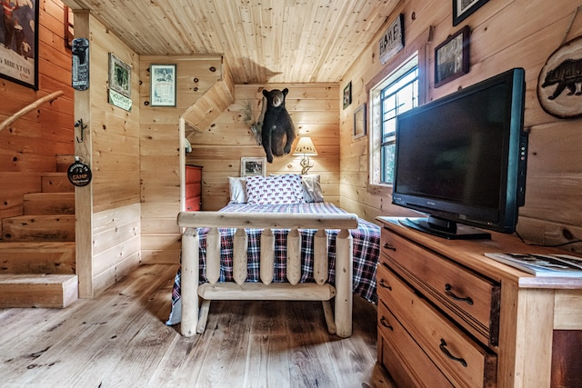 unfurnished bedroom with wood-type flooring, wooden walls, and wooden ceiling