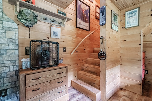 mudroom featuring wood walls, light wood-type flooring, and wood ceiling